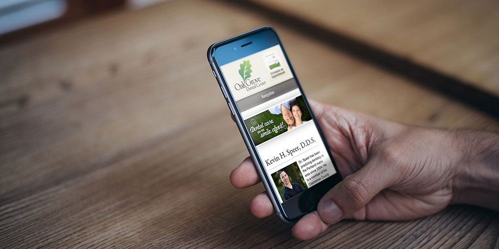 Oak Grove Dental Center website on a smartphone